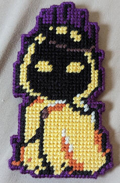 A yarn figure of John Doe from the horror podcast Malevolent