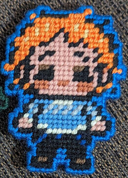 A yarn figure of Martin Blackwood from the horror podcast The Magnus Archives