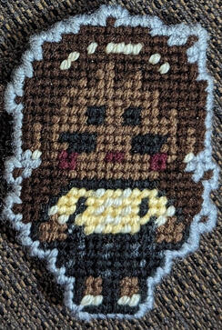 A yarn figure of Sasha James from the horror podcast The Magnus Archives